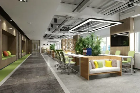 A well-lit, open office design featuring stylish seating areas, explaining visually what a commercial interior designer brings to corporate layouts.