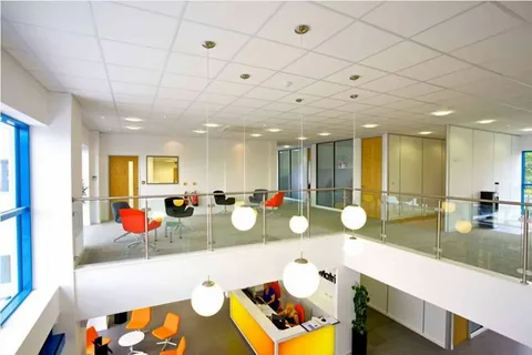 Modern office interior layout highlighting what a commercial interior designer plans for collaborative business environments.