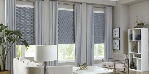 Cozy sitting area with a chair and indoor plants next to large windows with stylish Window Treatments